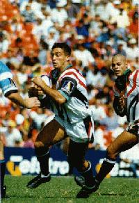 Carl Macnamara makes a run with Morvin Edwards in support.